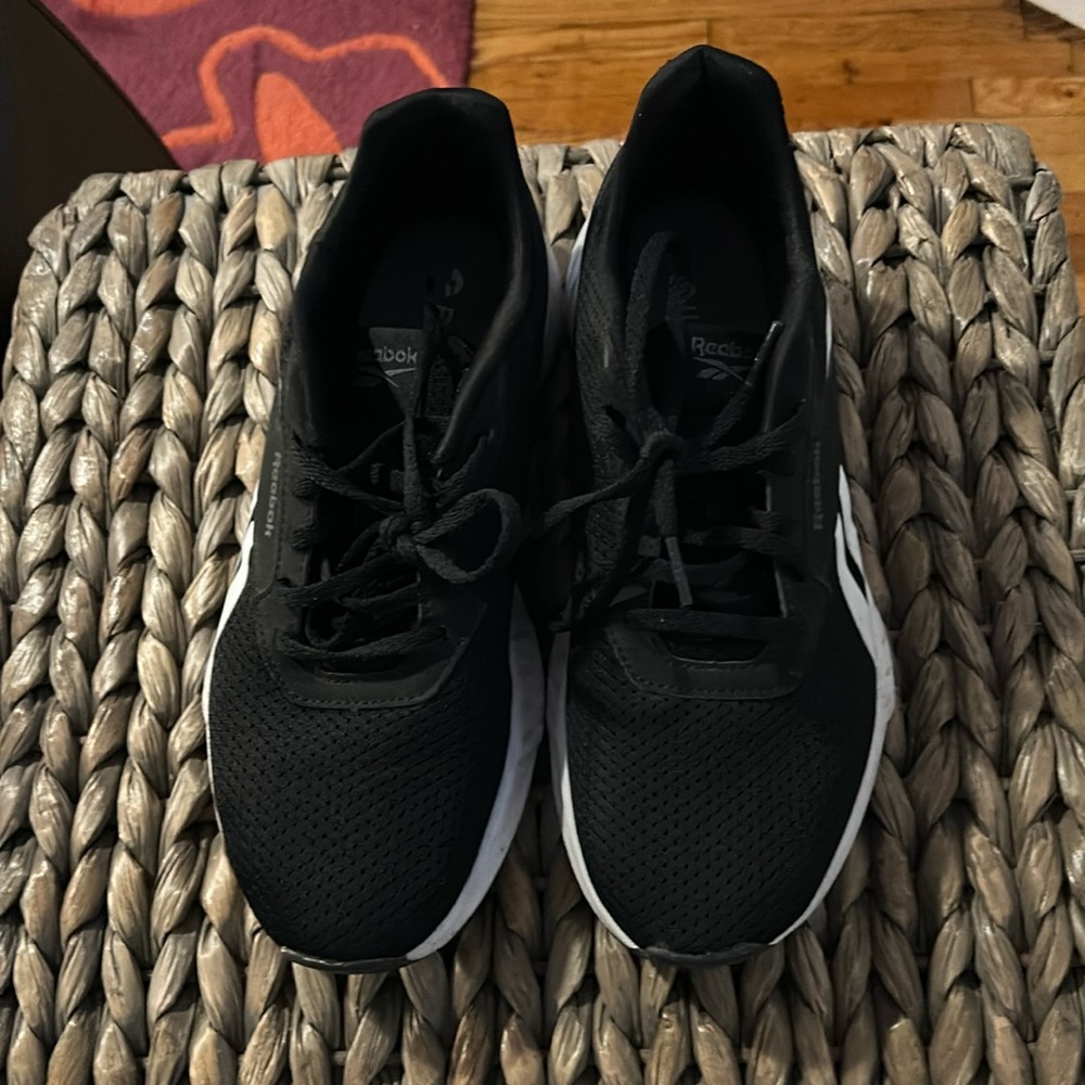 Black and white Reebok running shoes